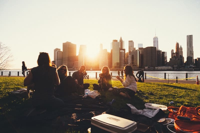 group of women sitting in front of NYC skyline